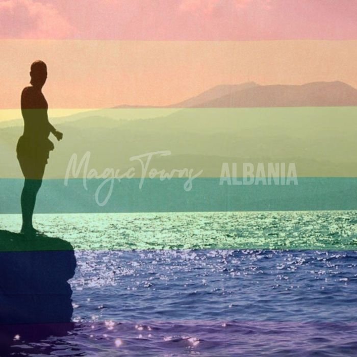 person standing near a cliff with an ocean in the background